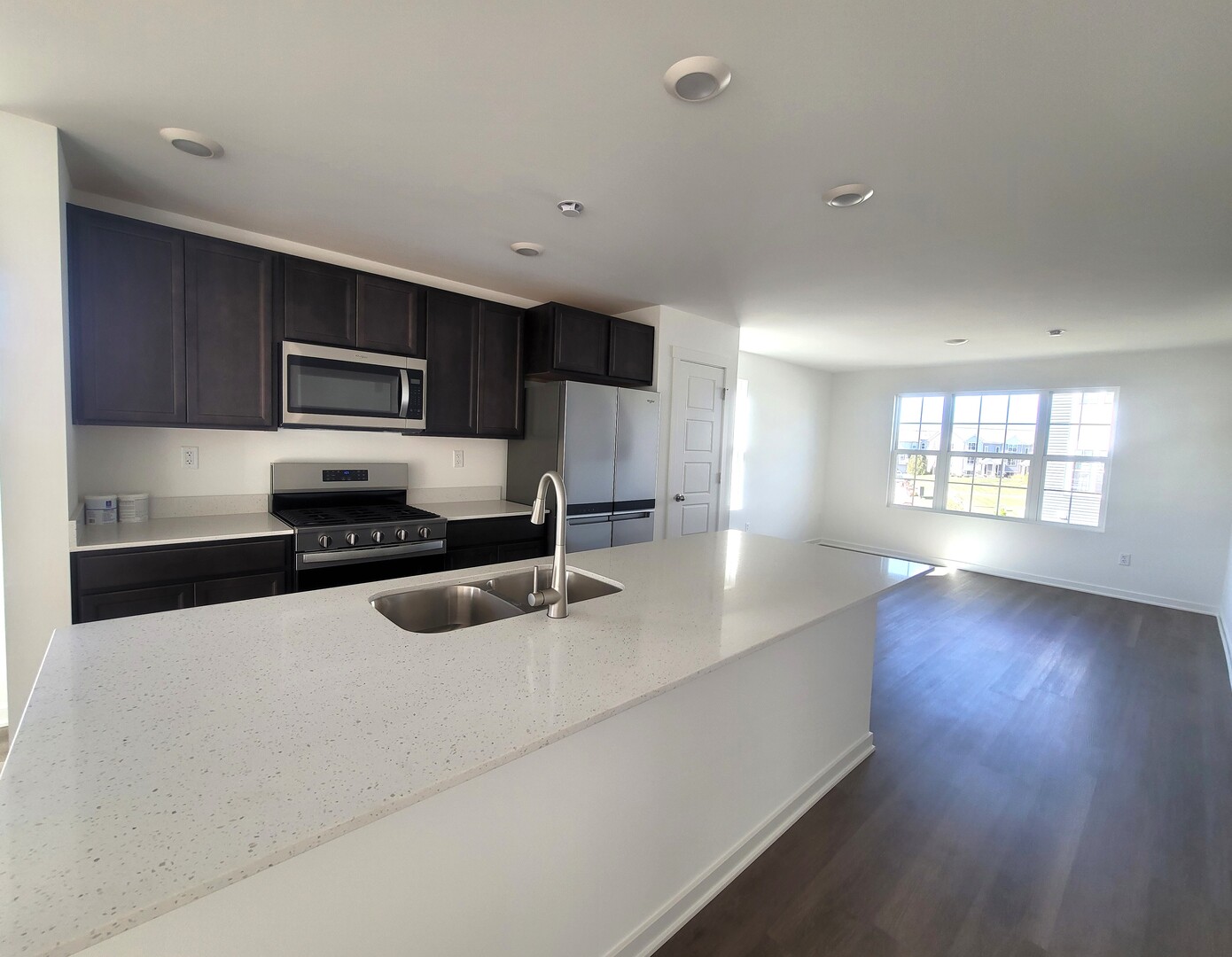 6550 Linden Trail, Unit F Wonder Lake, IL 60097 - Photo 5 of 18 a kitchen with granite countertop a sink a counter top space appliances and cabinets