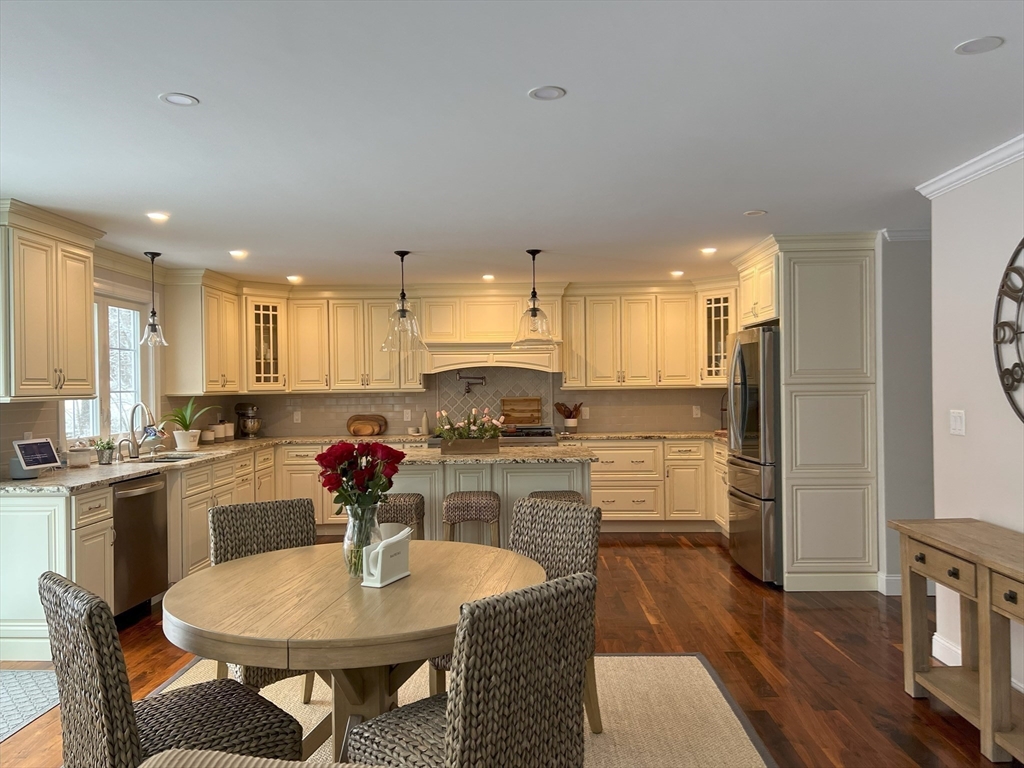 69 Narrows Road Assonet, MA 02702 - Photo 24 of 40 a kitchen with refrigerator a sink and chairs