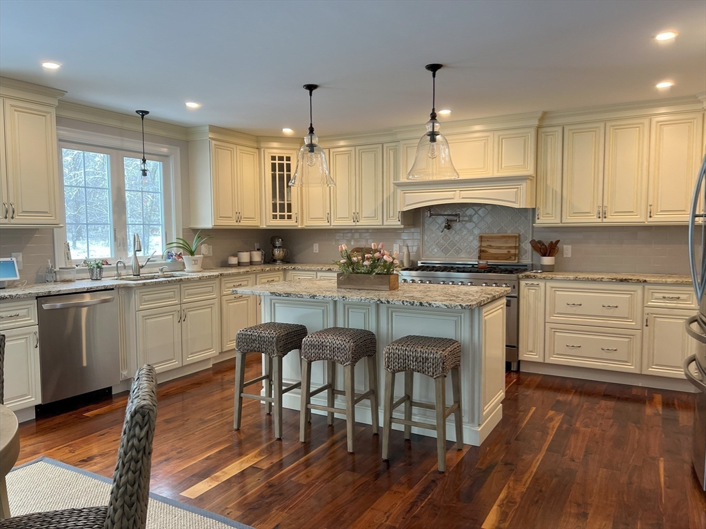 69 Narrows Road Assonet, MA 02702 - Photo 26 of 40 a kitchen with a table chairs cabinets and wooden floor