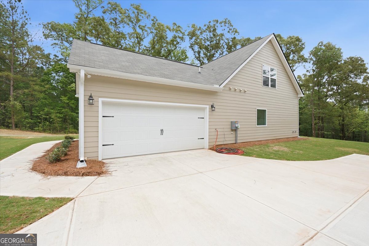 2778 Boxankle Road Forsyth, GA 31029 - Photo 19 of 21 a view of a white house with a yard and potted plants