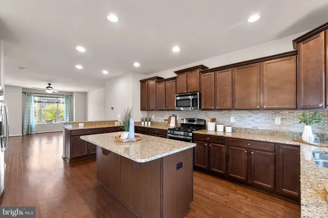a kitchen with a sink cabinets and wooden floor