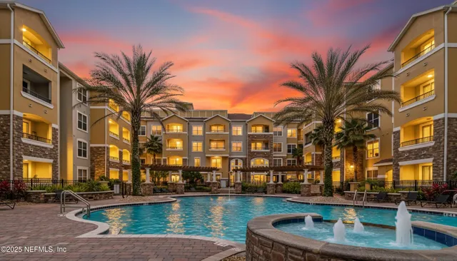 a view of building with swimming pool and sitting area