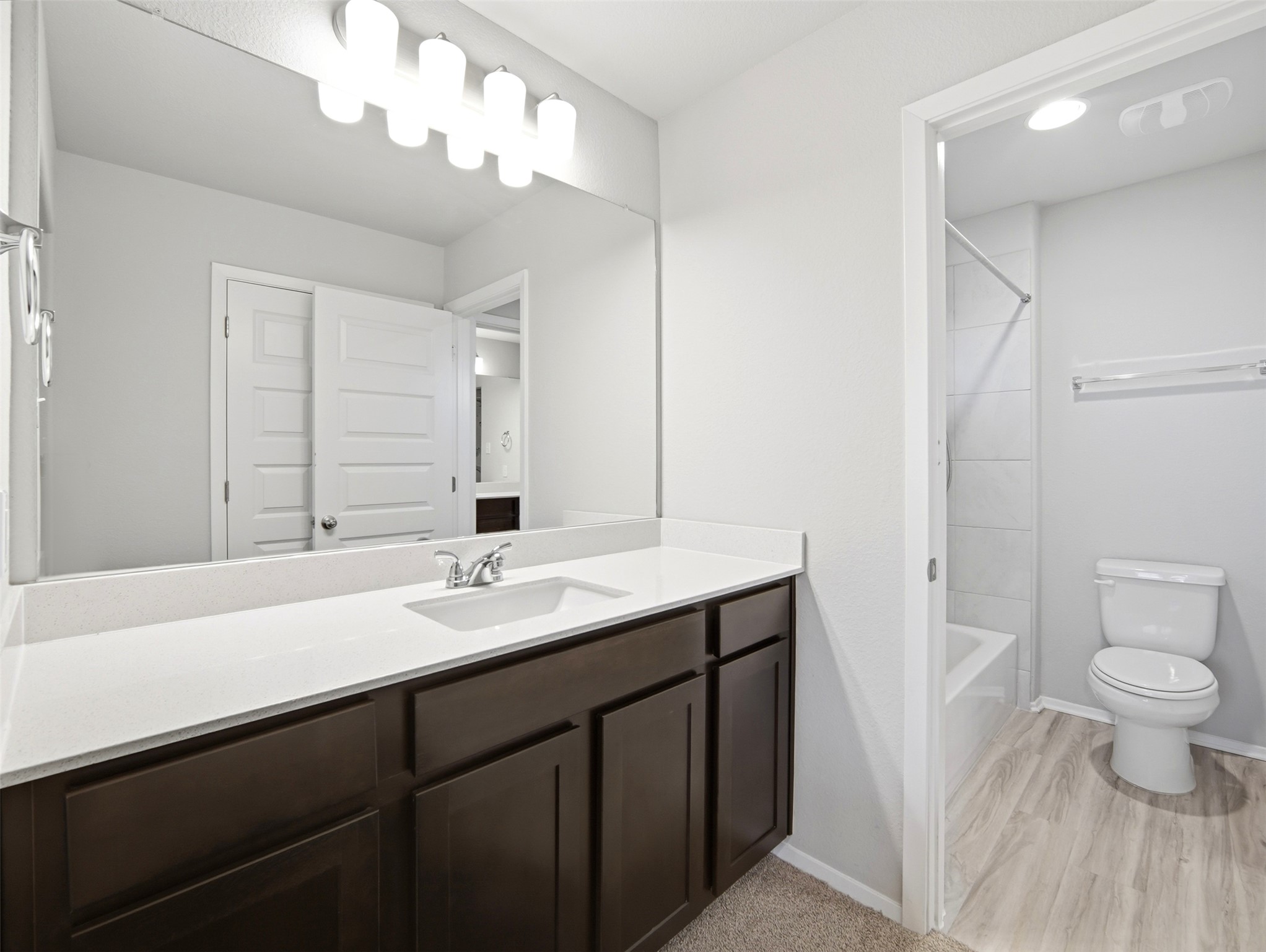 60 Bent Trl Lane Georgetown, TX 78628 - Photo 29 of 40 A well-lit vanity with ample counter space and an adjacent shower/tub combo.