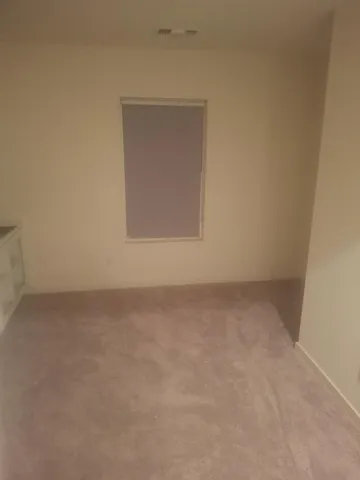 wooden floor with view of entryway with wooden floor