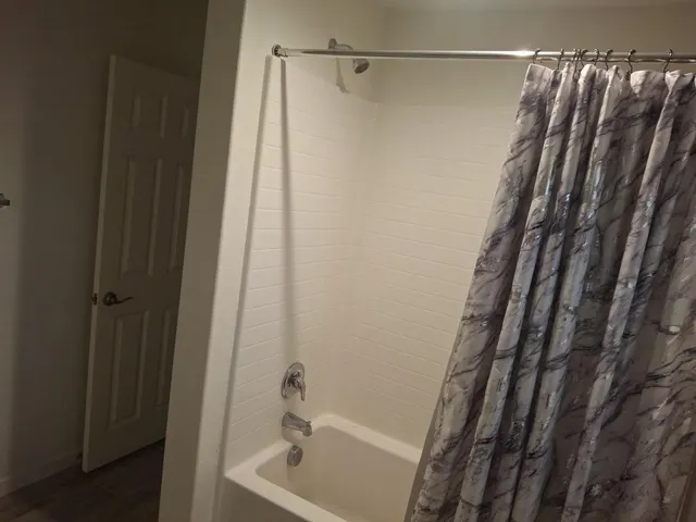 a white toilet sitting next to a white wall