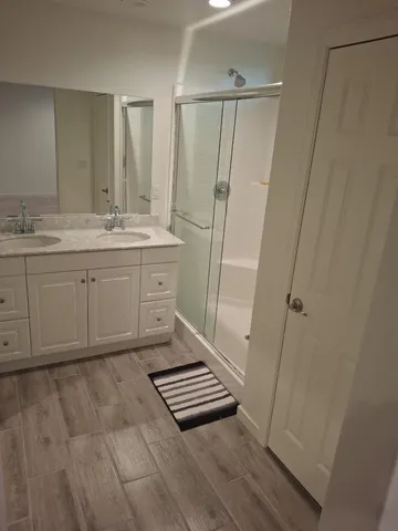 a spacious bathroom with a granite countertop sink toilet and a mirror