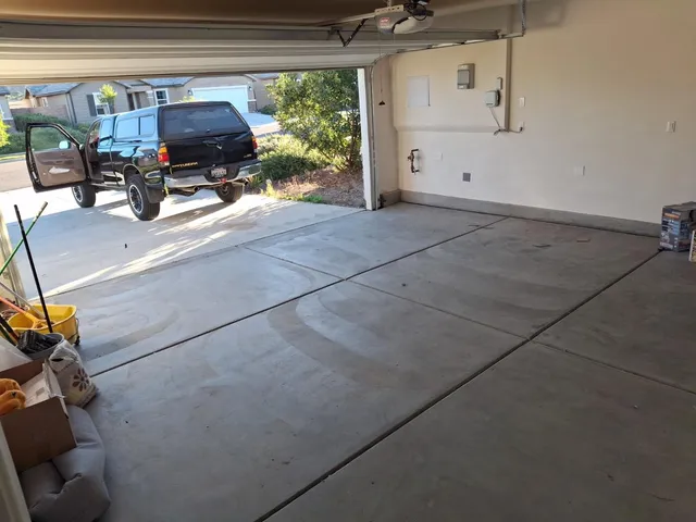 a front view of a house with cars parked