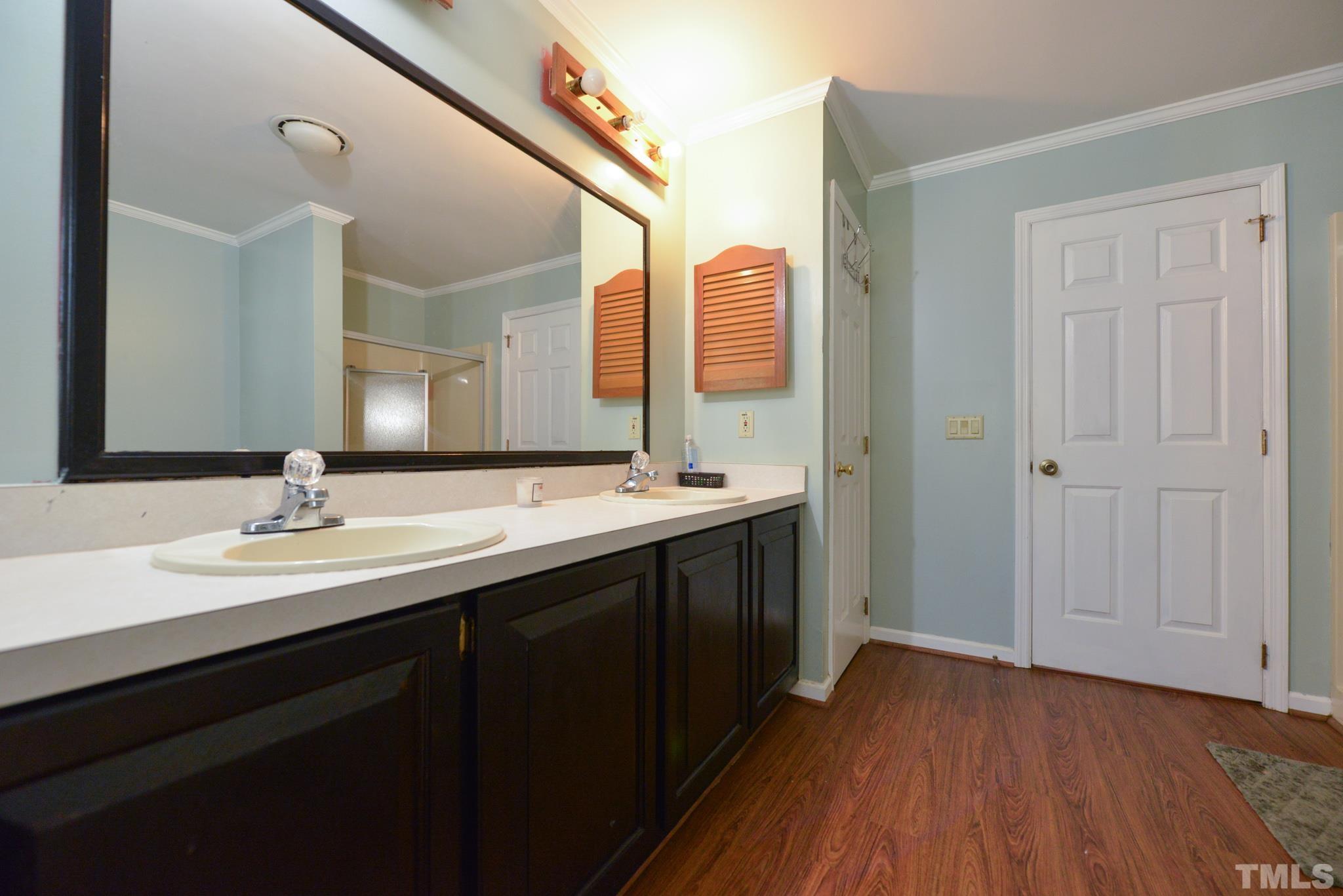 7657 G High Road Sims, NC 27880 - Photo 14 of 27 a bathroom with a double vanity sink and mirror
