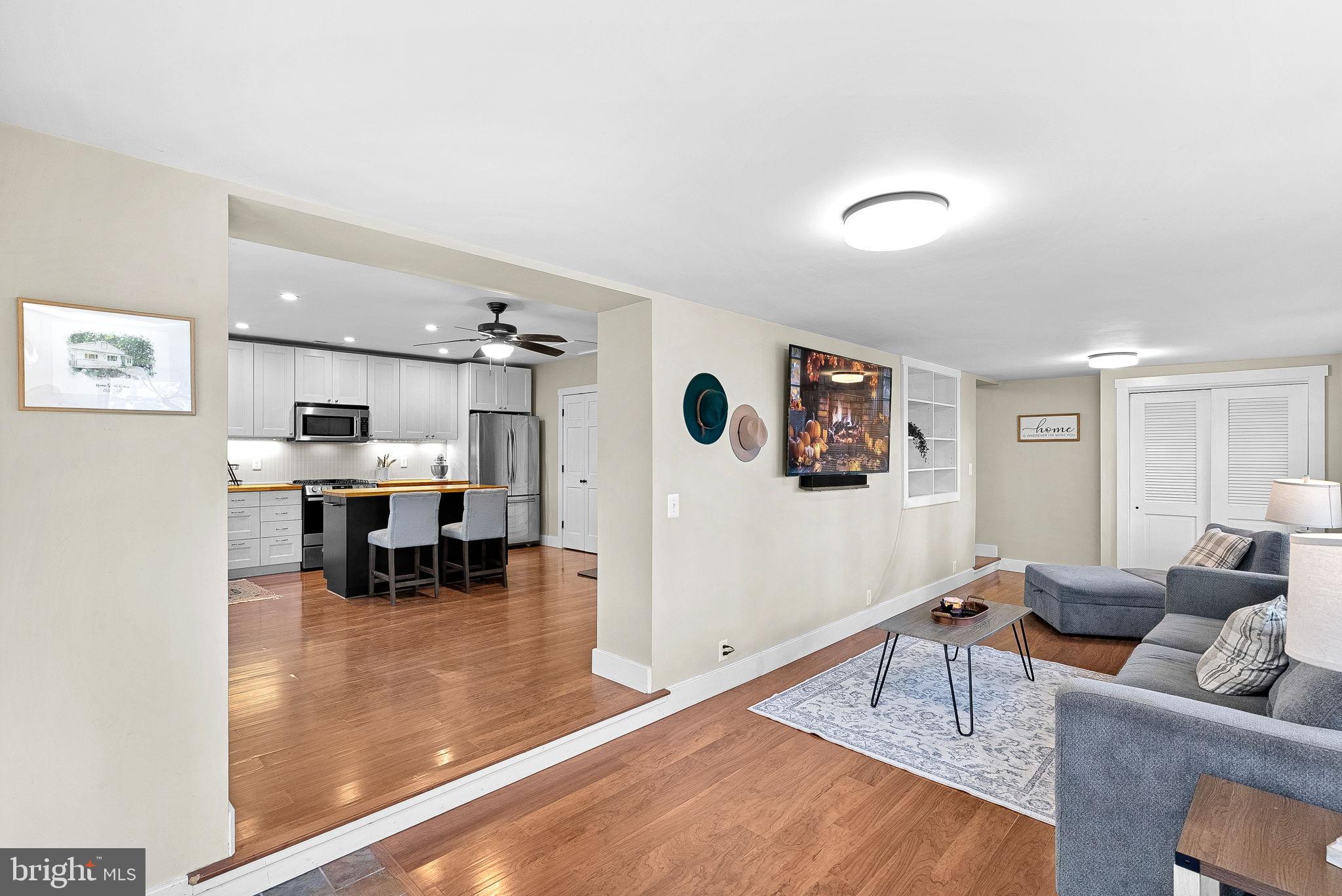 a living room with furniture and view of kitchen