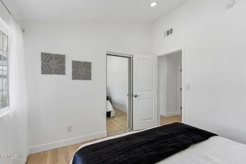 a view of bedroom with wooden floor