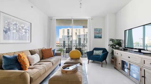 a living room with furniture and a mirror