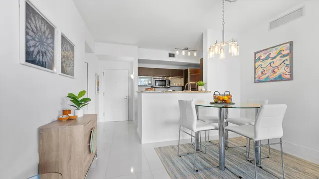 a dining room with furniture wooden floor and a chandelier