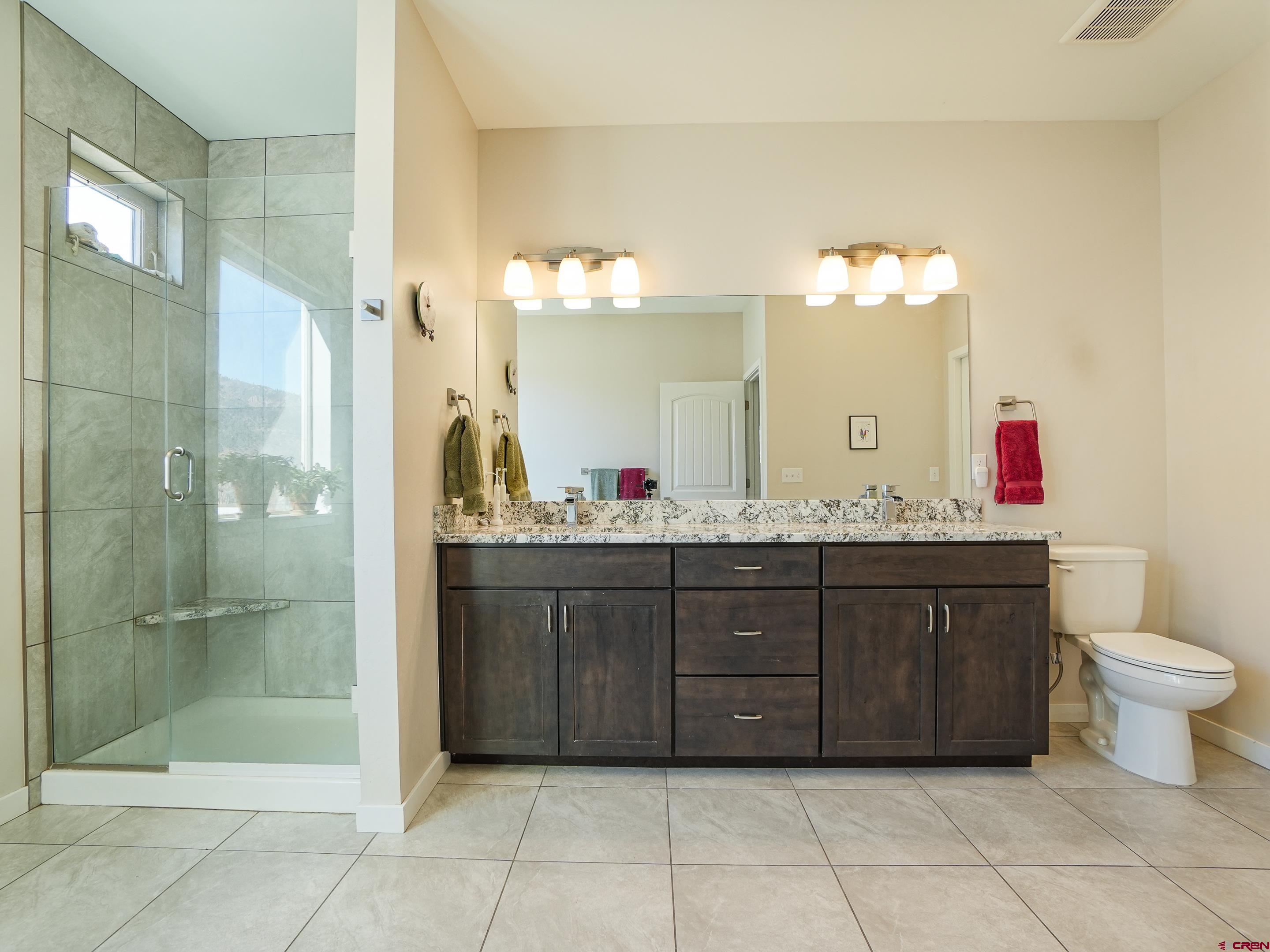 1422 Animas View Drive, Unit 18 Durango, CO 81301 - Photo 12 of 16 a bathroom with a bathtub shower sink mirror and toilet