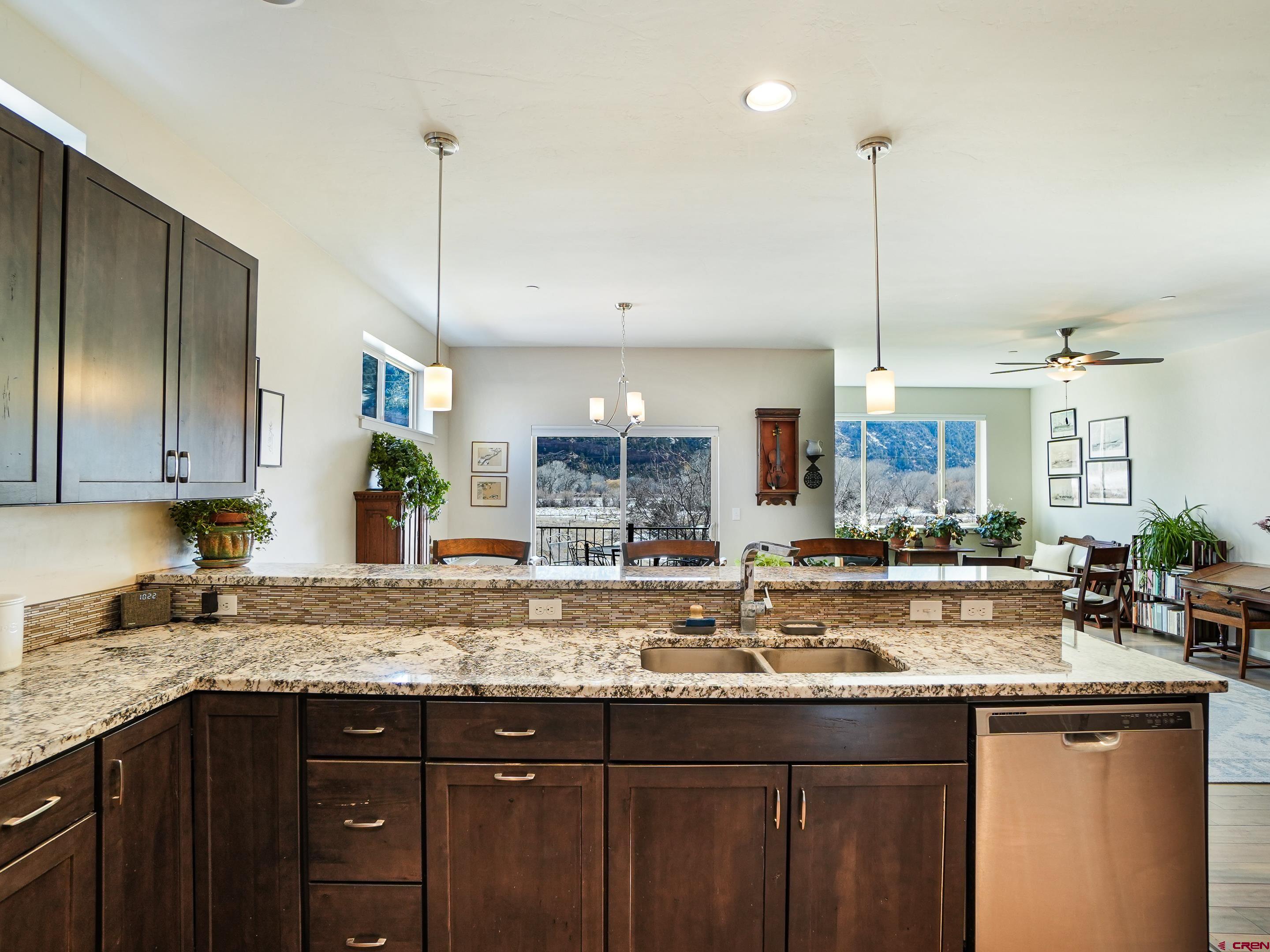 1422 Animas View Drive, Unit 18 Durango, CO 81301 - Photo 3 of 16 a kitchen with granite countertop a sink a counter space appliances and cabinets