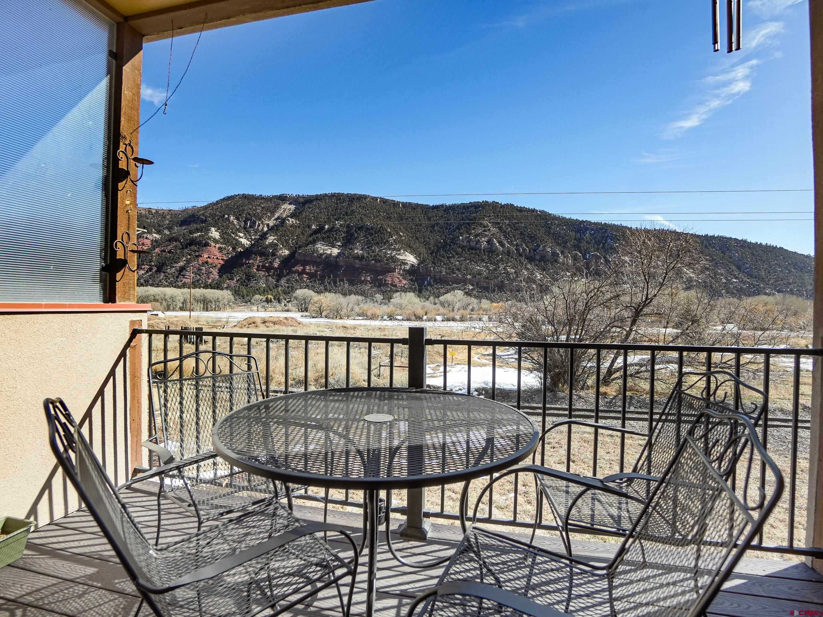 1422 Animas View Drive, Unit 18 Durango, CO 81301 - Photo 7 of 16 a view of a balcony with table and chairs
