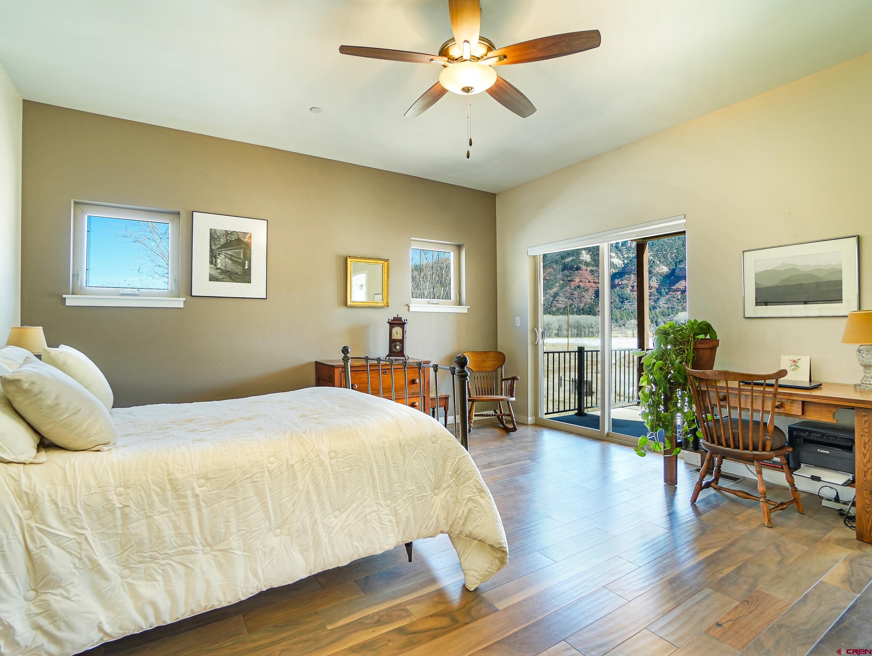 1422 Animas View Drive, Unit 18 Durango, CO 81301 - Photo 9 of 16 a bedroom with a bed and wooden floor