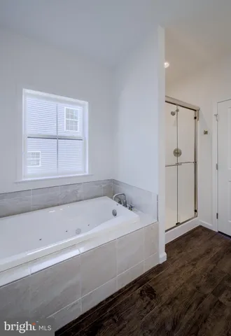 a bathroom with a bathtub and a window