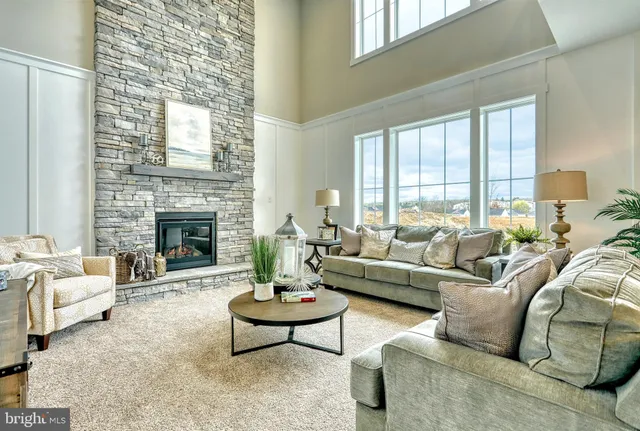 a living room with furniture fireplace and a table