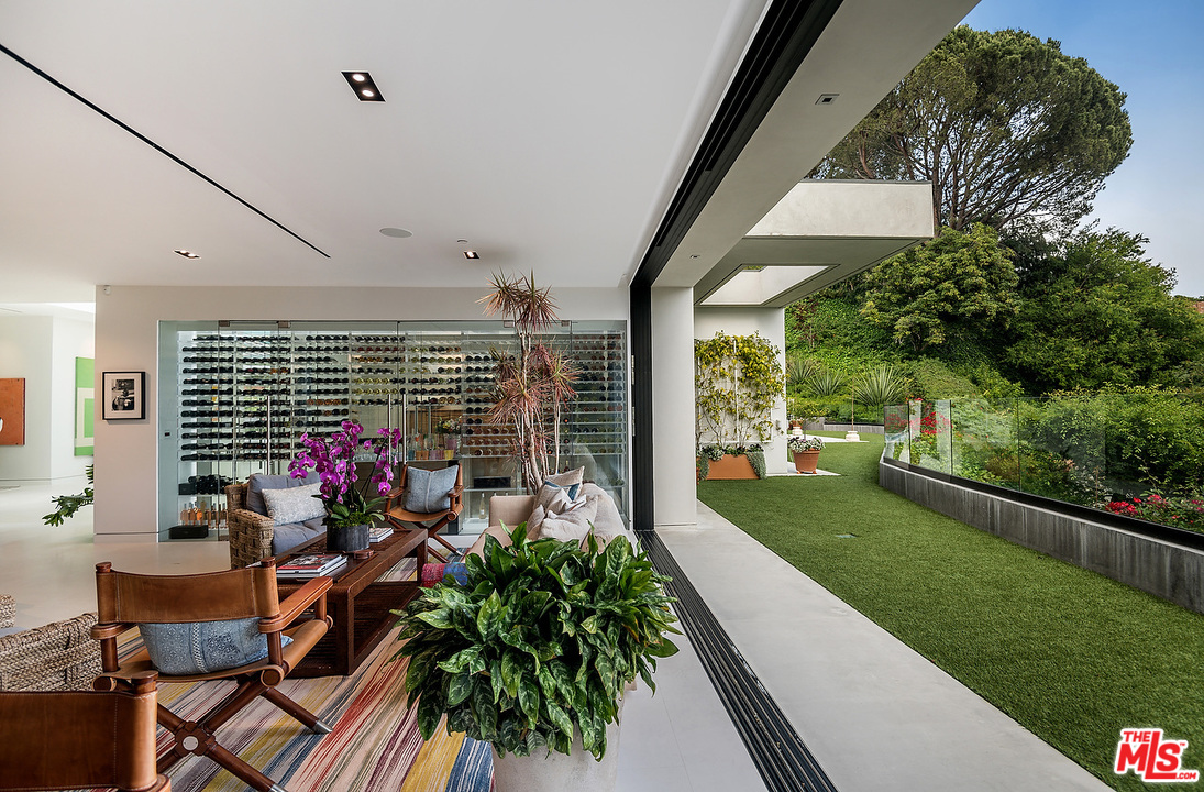1012 North Hillcrest Road Beverly Hills, CA 90210 - Photo 28 of 54 a view of a porch with furniture and garden