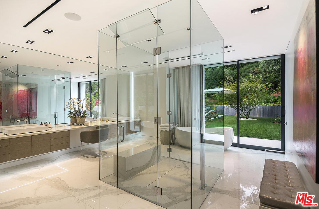 1012 North Hillcrest Road Beverly Hills, CA 90210 - Photo 34 of 54 a large white room with a large window and table