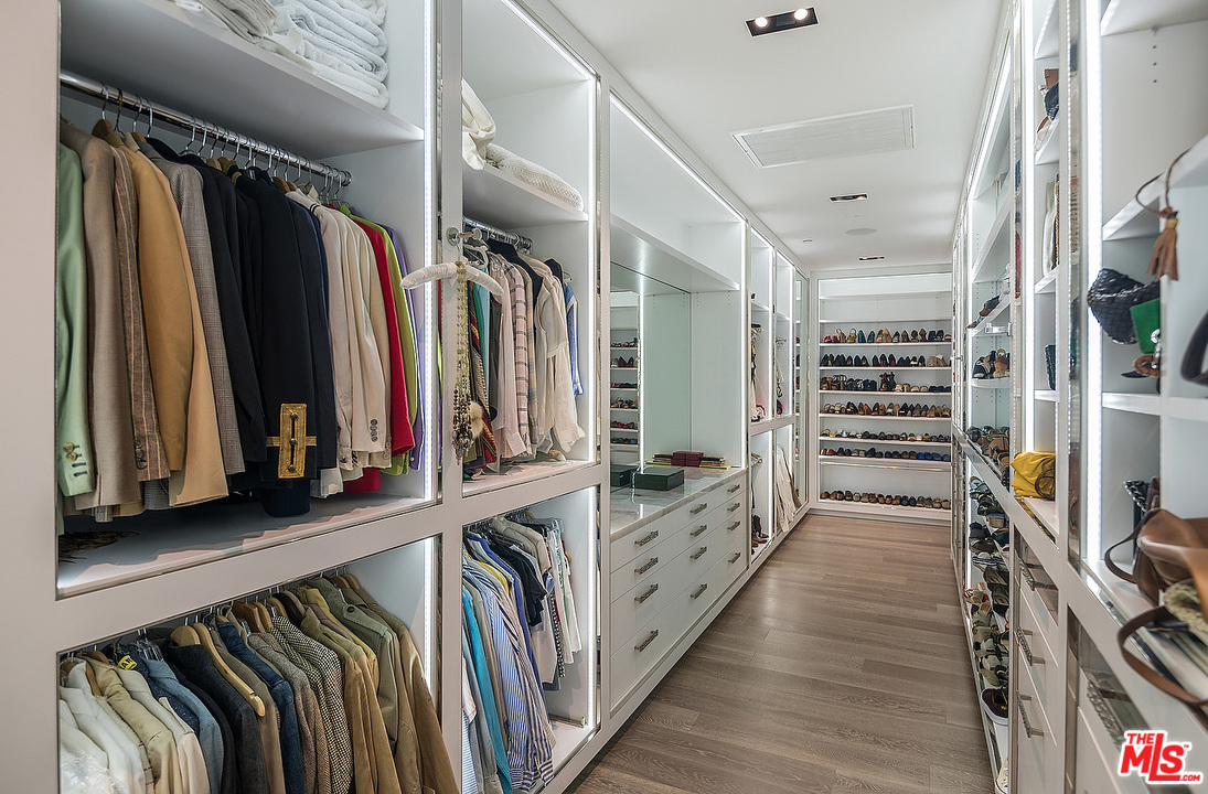 1012 North Hillcrest Road Beverly Hills, CA 90210 - Photo 37 of 54 a view of walk in closet with clothes and shoes