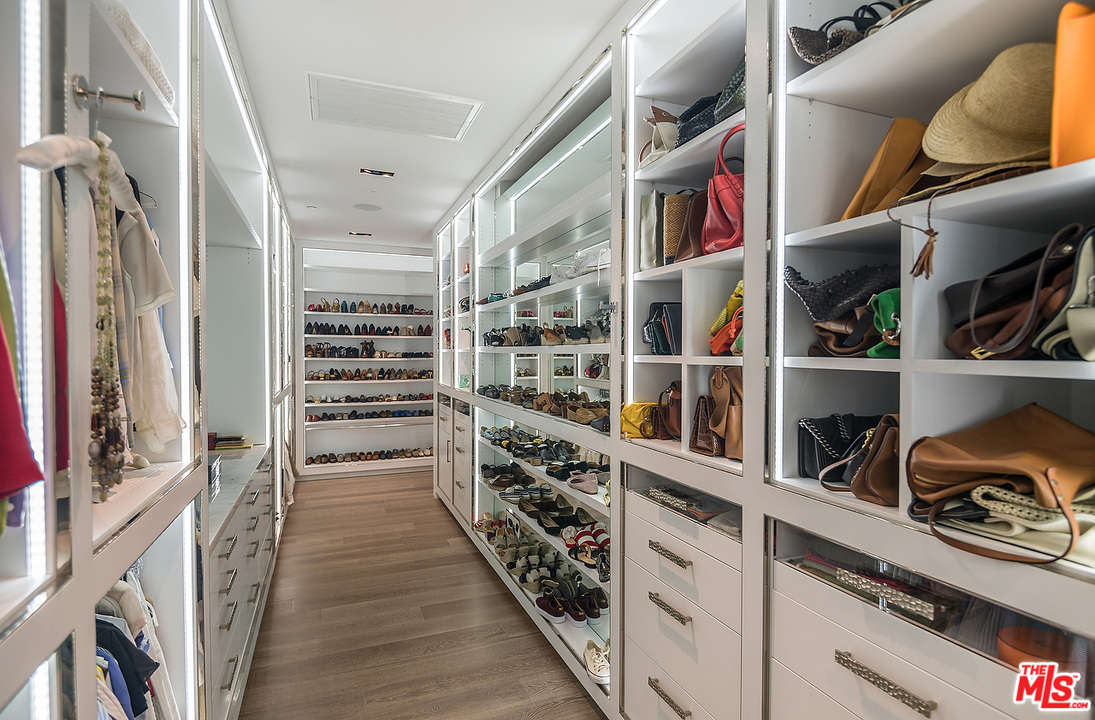 1012 North Hillcrest Road Beverly Hills, CA 90210 - Photo 38 of 54 a view of walk in closet with clothes and shoes