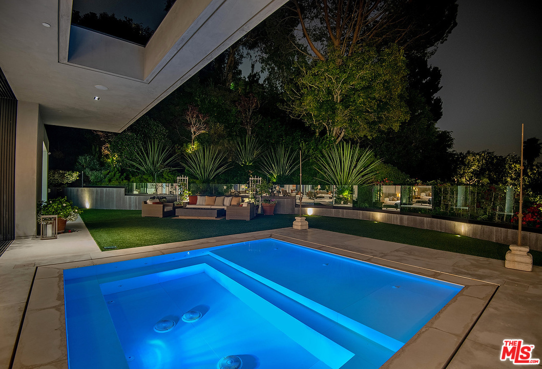 1012 North Hillcrest Road Beverly Hills, CA 90210 - Photo 53 of 54 a view of swimming pool with seating area and garden