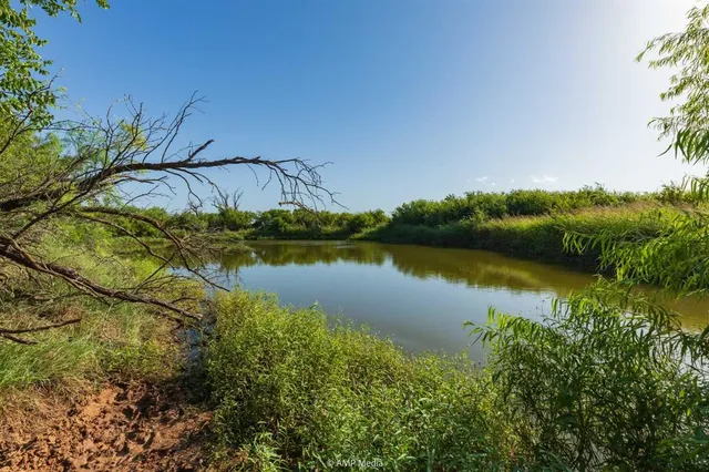 a view of a lake with a house in the background