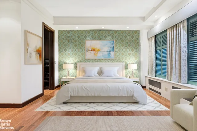 a bedroom with a bed and a large window