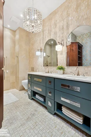a bathroom with a sink double vanity and a mirror