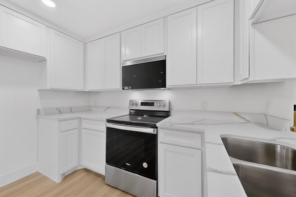 2219 Wilbur Street Dallas, TX 75224 - Photo 11 of 37 a kitchen with cabinets stainless steel appliances and a sink