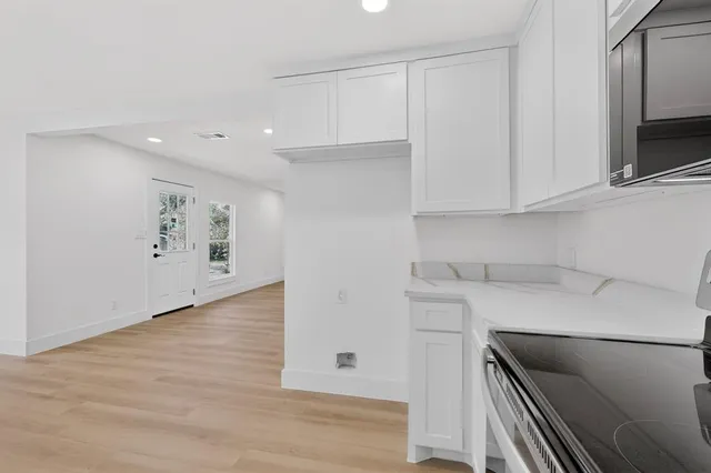 a kitchen with cabinets stainless steel appliances and a sink