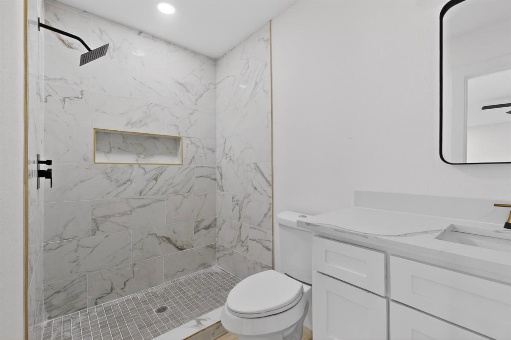 2219 Wilbur Street Dallas, TX 75224 - Photo 18 of 37 a bathroom with a shower toilet and sink