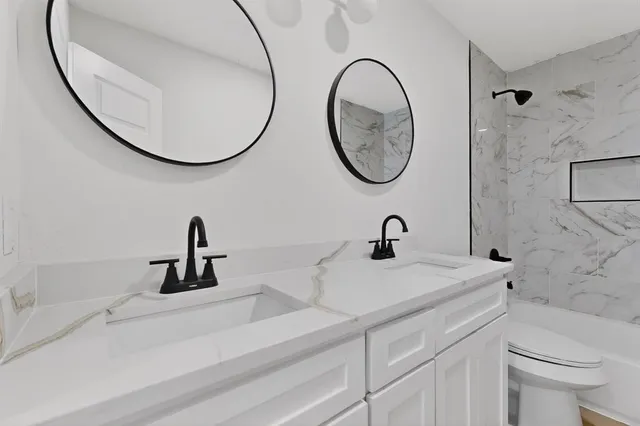 a bathroom with a toilet sink and mirror