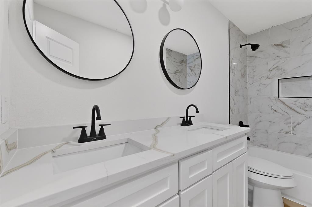 2219 Wilbur Street Dallas, TX 75224 - Photo 24 of 37 a bathroom with a sink and a mirror