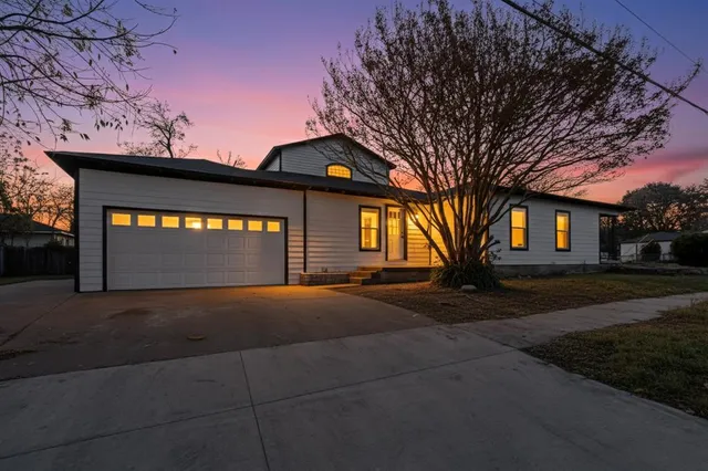 a view of a house with a snow in front of yard