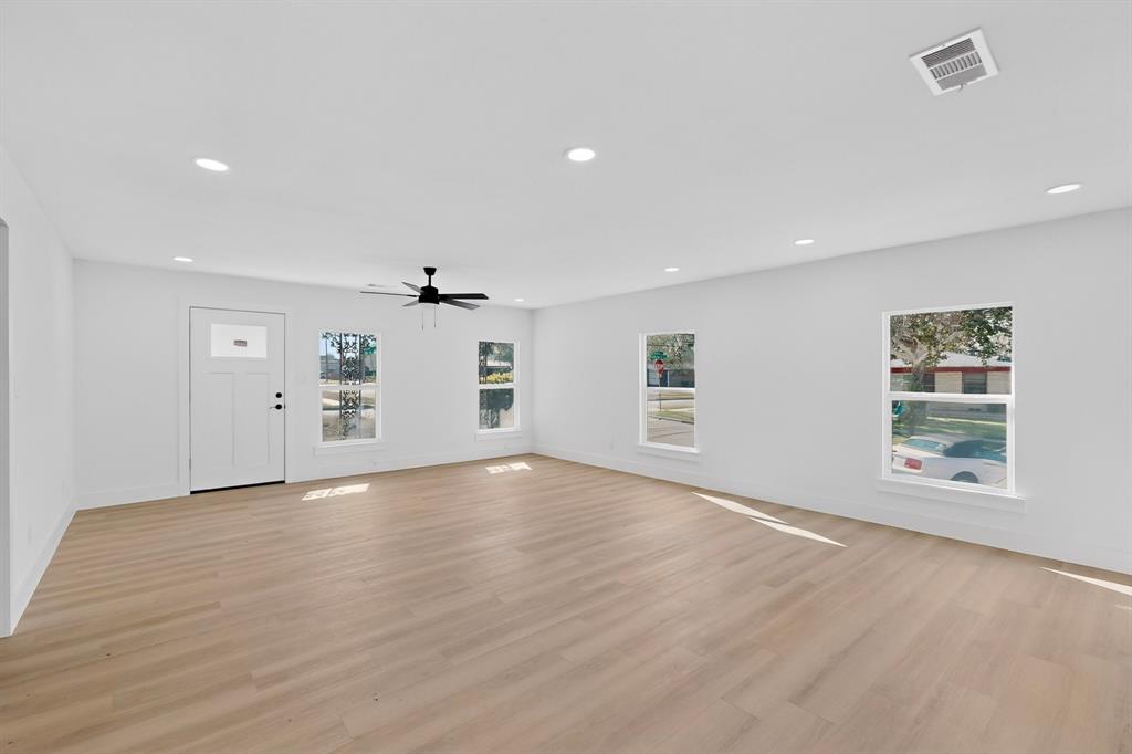 2219 Wilbur Street Dallas, TX 75224 - Photo 6 of 37 wooden floor in an empty room with a window