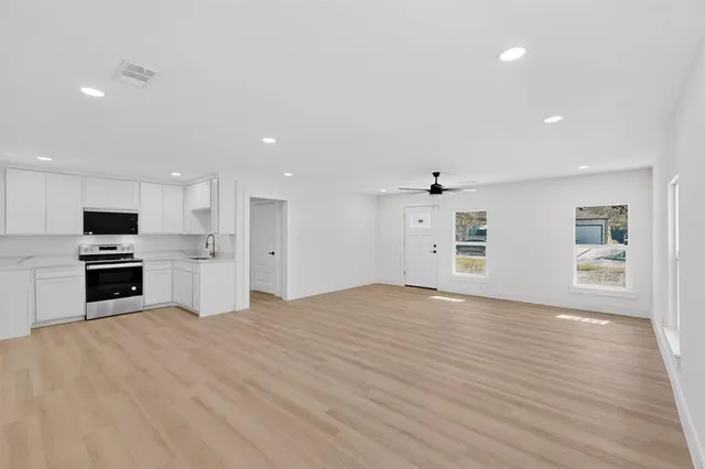 a large kitchen with kitchen island a sink stainless steel appliances and cabinets