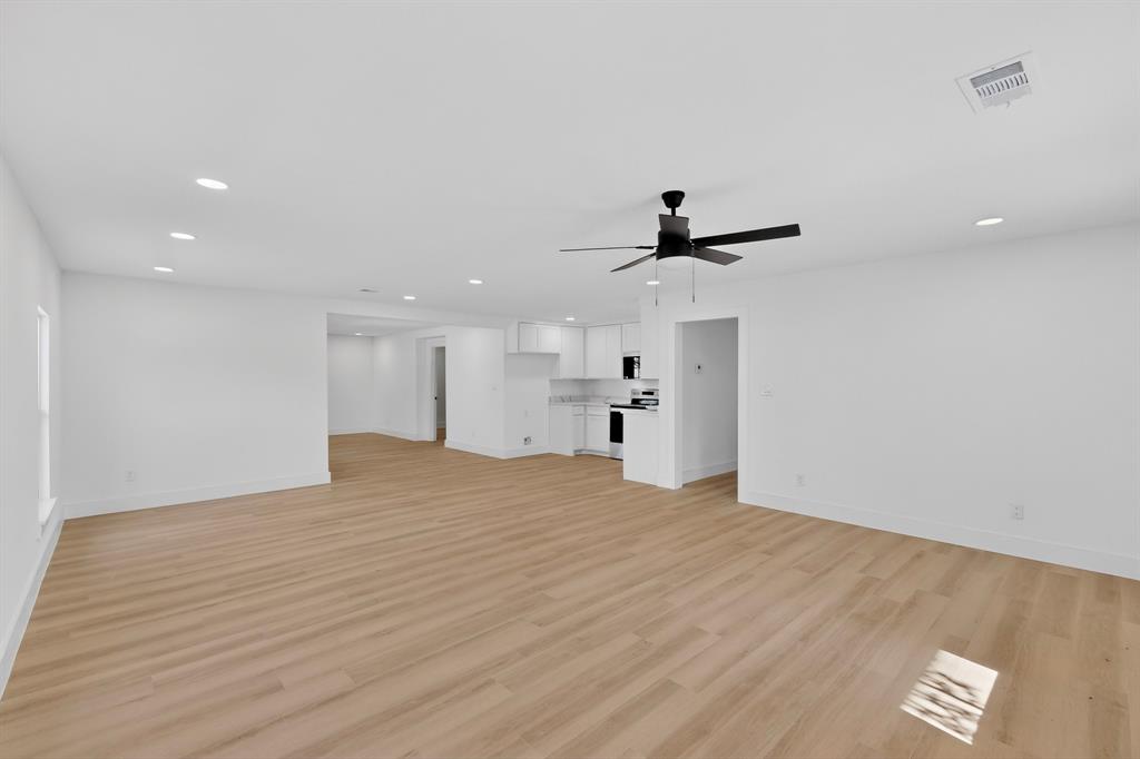 2219 Wilbur Street Dallas, TX 75224 - Photo 8 of 37 a view of empty room with wooden floor and windows