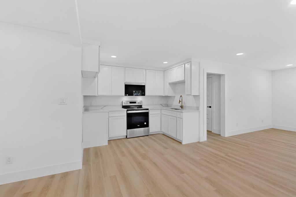 2219 Wilbur Street Dallas, TX 75224 - Photo 37 of 37 a kitchen with white cabinets and stainless steel appliances