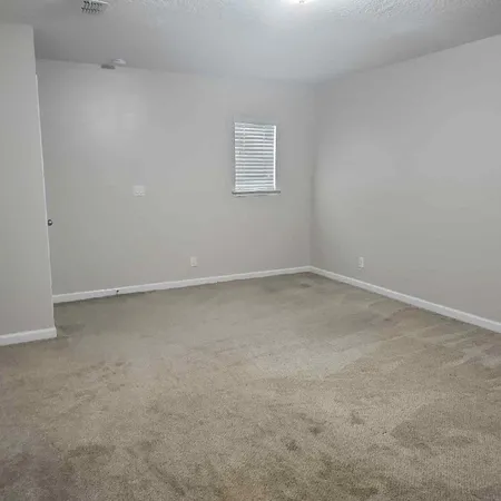 a view of an empty room and closet area