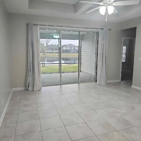 a view of an empty room with a ceiling fan