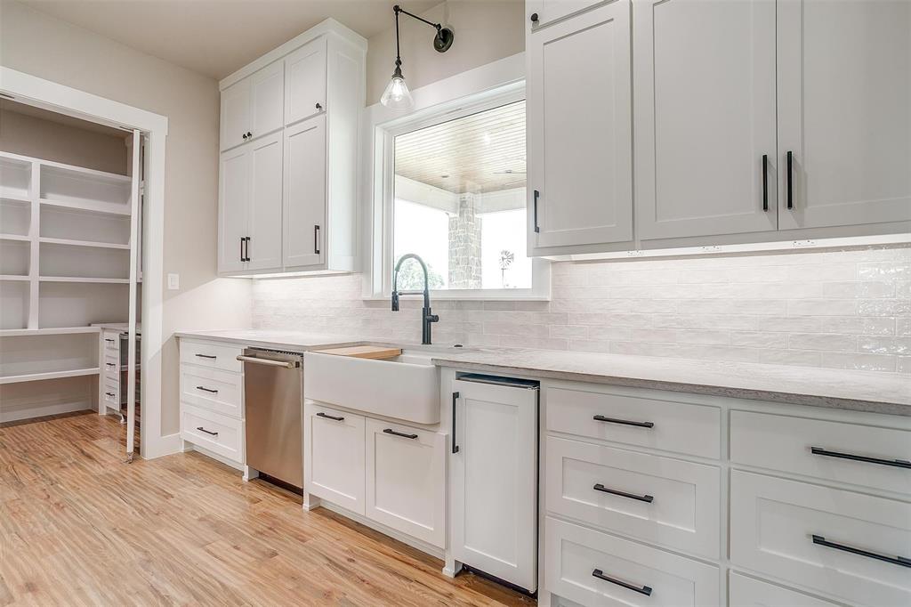 3019 Orchard Road Bowie, TX 76230 - Photo 16 of 40 a kitchen with white cabinets and sink