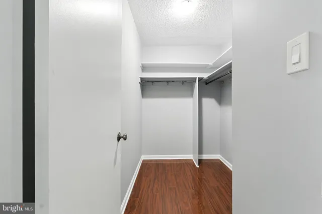 a view of hallway with wooden floor