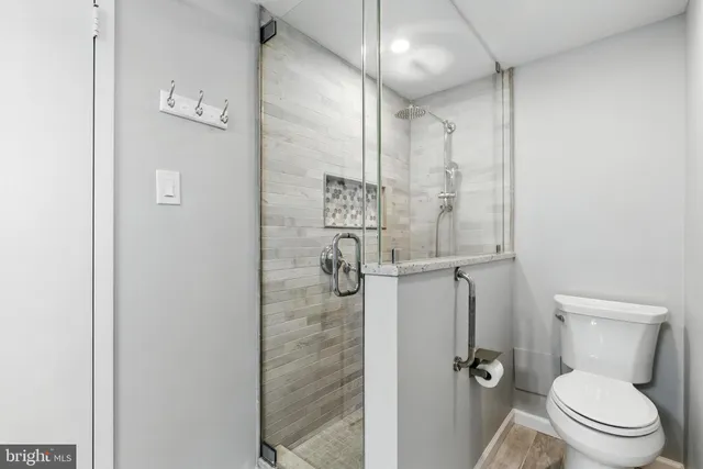 a bathroom with a toilet and a shower