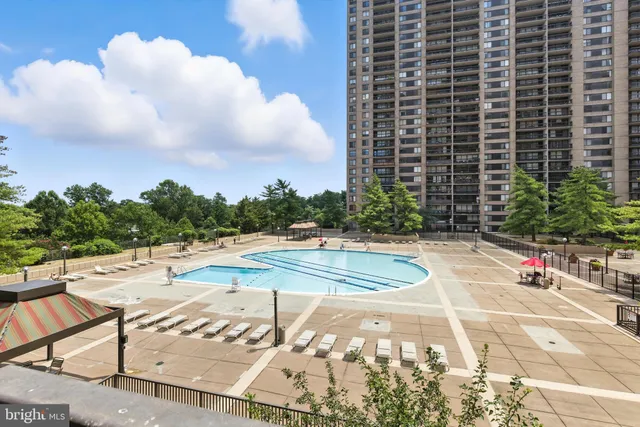 a view of a swimming pool and a yard