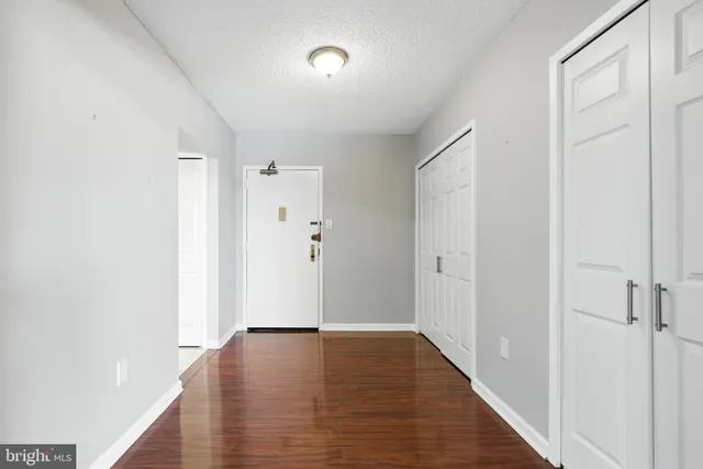 a view of hallway with wooden floor