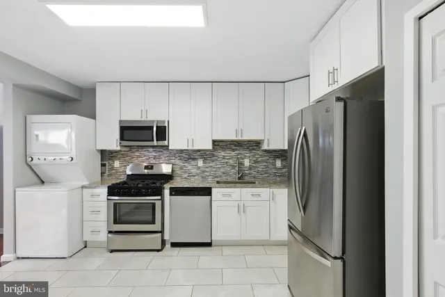 a kitchen with stainless steel appliances a refrigerator sink and stove