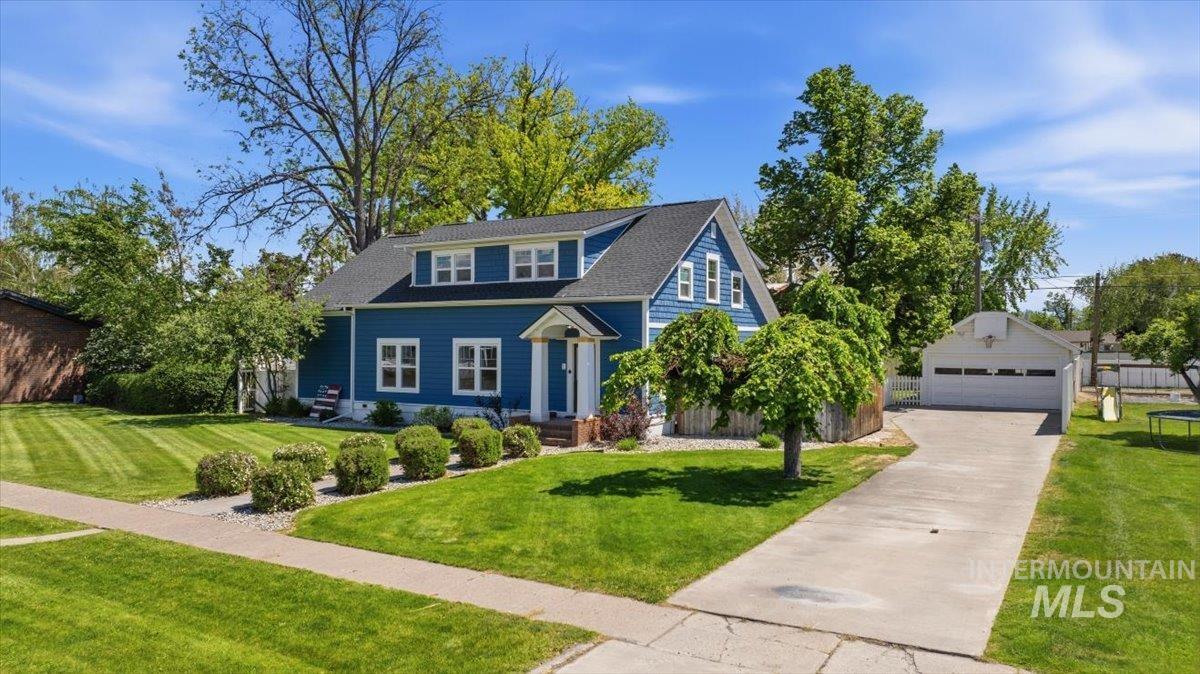 813 7th Street Rupert, ID 83350 - Photo 2 of 48 Blue exterior home featuring a dormered roofline, white trim, and a covered entry