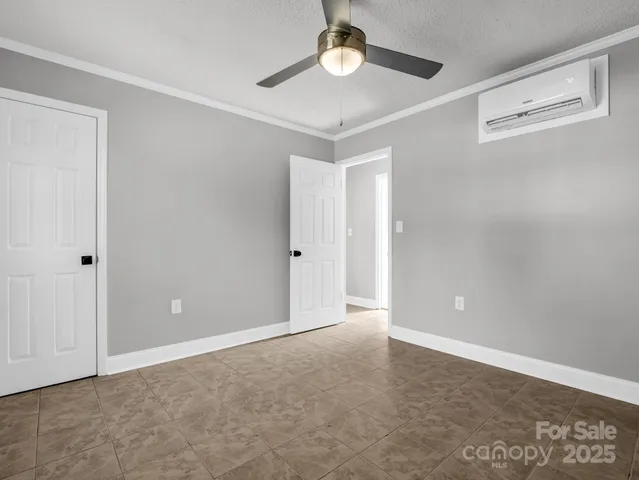 a view of an empty room with a ceiling fan